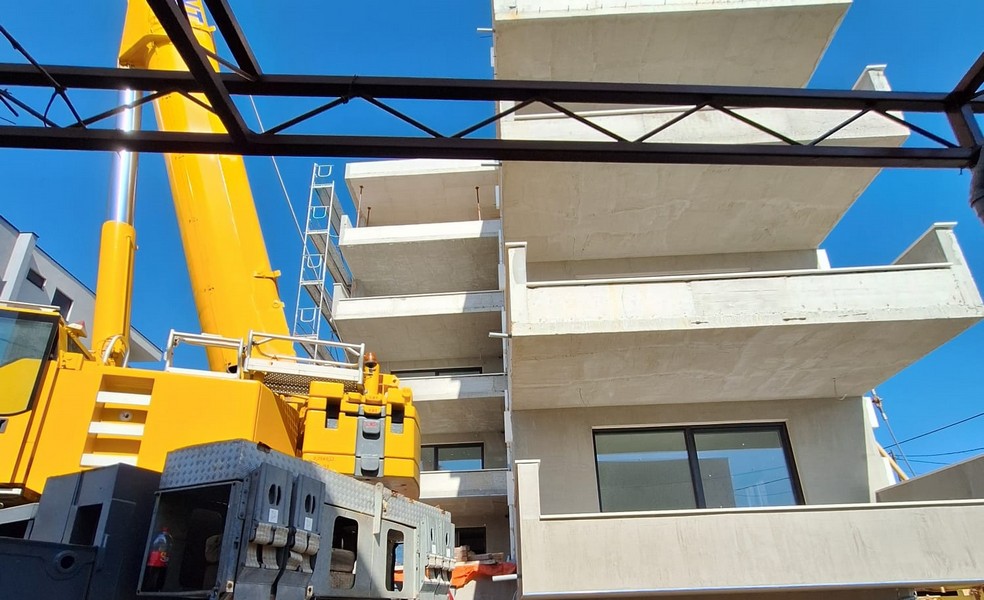 Jeřábnické práce na novostavbě činžovního domu s výhledem na okolní architekturu v Chorvatsku nabízí Panorama Scouting