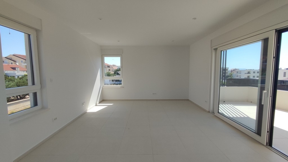 Nedokončený pokoj se vstupem na balkon a výhledem na moře