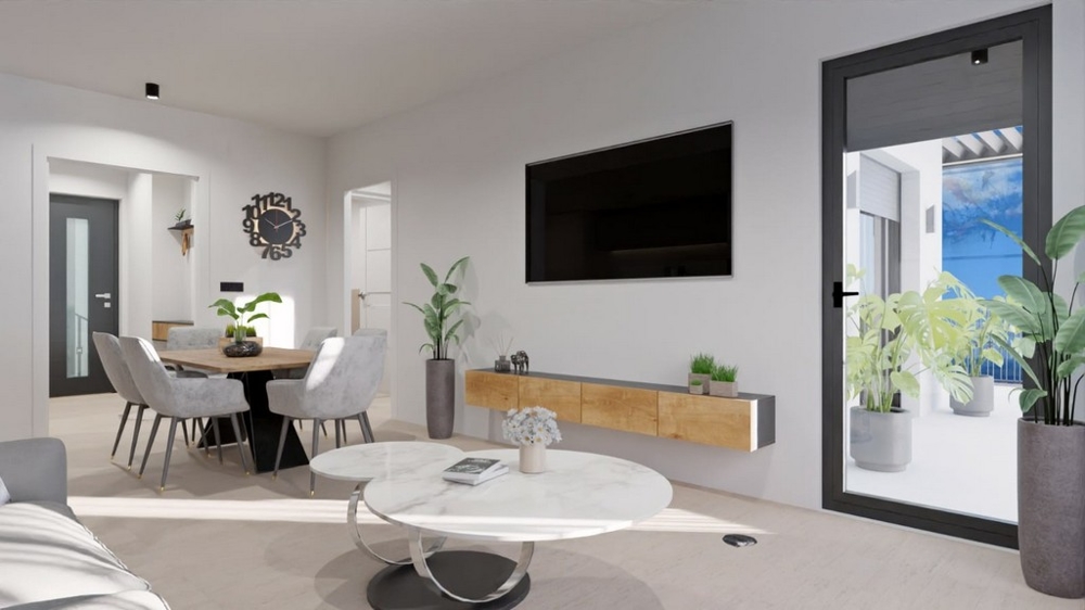 Moderní obývací pokoj s jídelním koutem, televizí a vstupem na balkon s výhledem na moře.