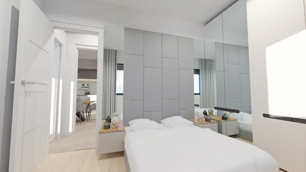 Světlá ložnice se zrcadly, bílým nábytkem a vstupem do obývacích pokojů.