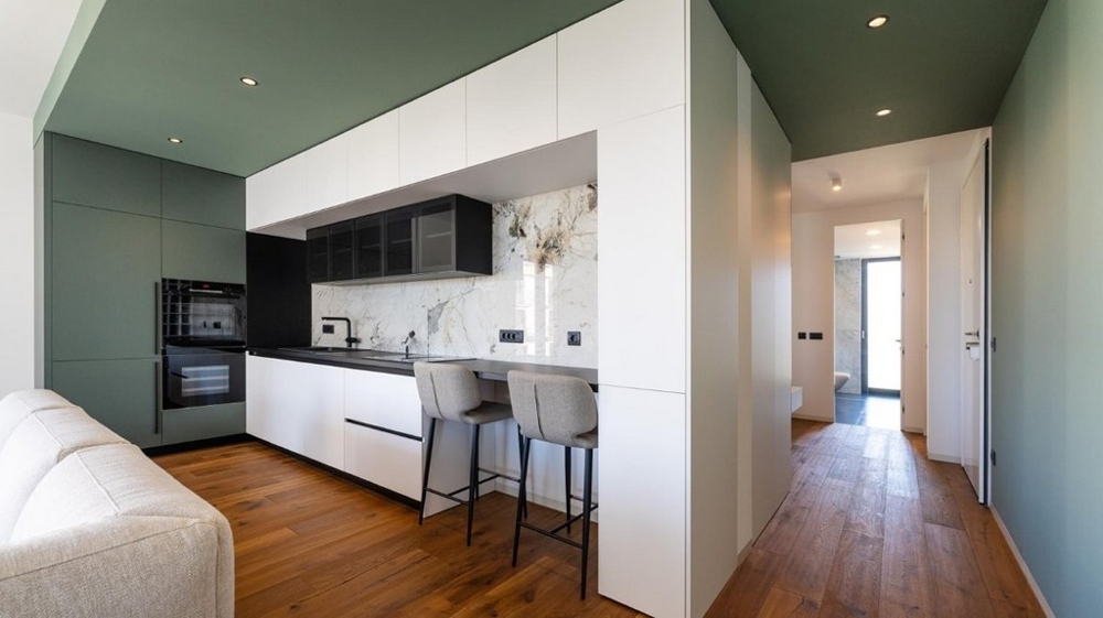 Kuchyň s barovými židlemi, vstup na chodbu, dřevěné podlahy