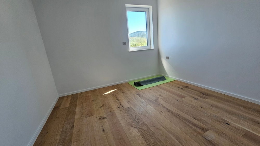 Ložnice s dubovým parketem a oknem s výhledem na moře, byt v novostavbě A3480