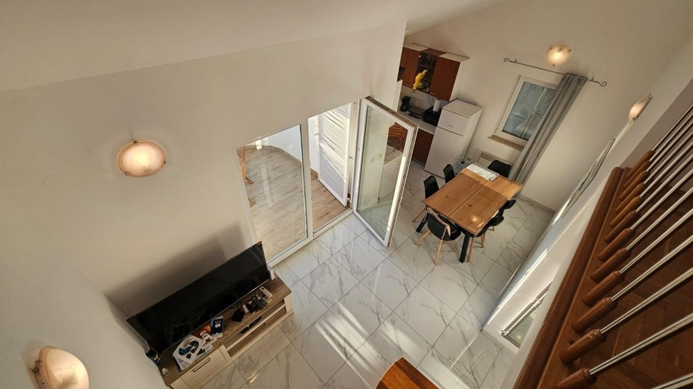 Pohled z galerie na obývací část a jídelní kout.