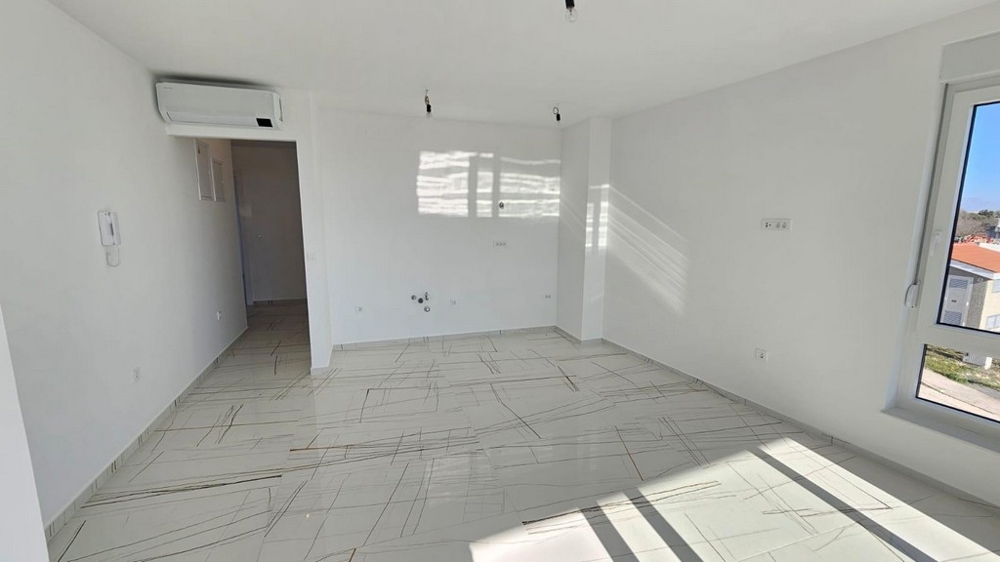 Světlý obývací pokoj s velkými okny a klimatizací