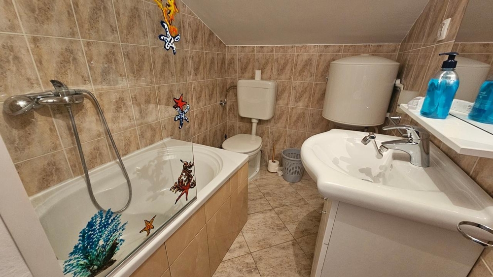 Koupelna s vanou a obklady