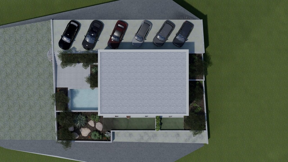 Pohled shora na obytné budovy s parkovacími místy a bazénem