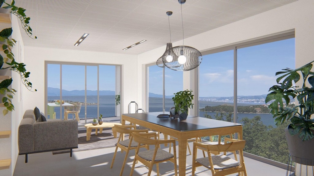 Světlý obývací pokoj s jídelním koutem a panoramatickým výhledem na moře