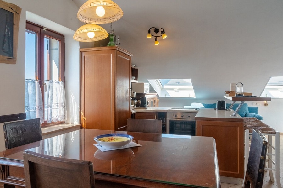 Obývací pokoj a kuchyň s jídelním stolem.