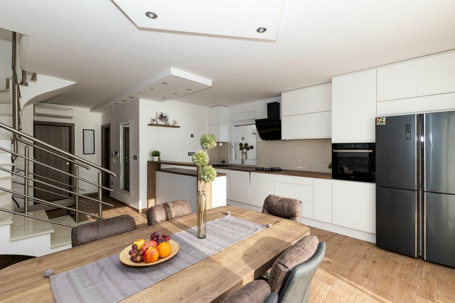 Moderní kuchyně s jídelním koutem a přístupem na schodiště