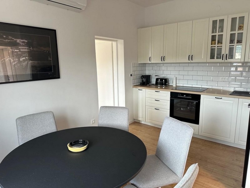 Jídelna s kulatým stolem a moderní kuchyní