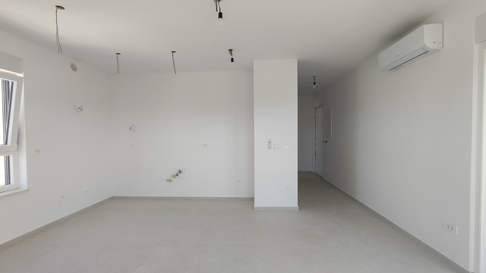 Otevřený prostor s připravenými přípojkami pro kuchyň