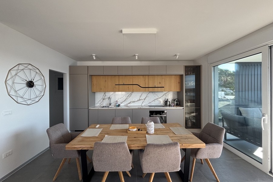 Moderně vybavená kuchyně s jídelním koutem a velkým oknem