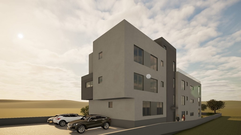 Novostavba bytového domu s parkovacími místy před budovou