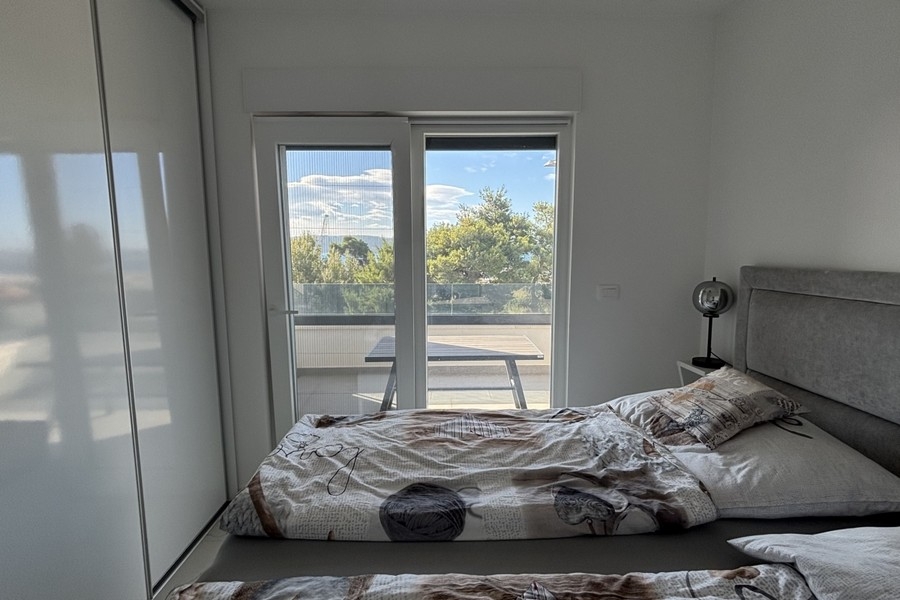 Ložnice se vstupem na balkon a výhledem na moře