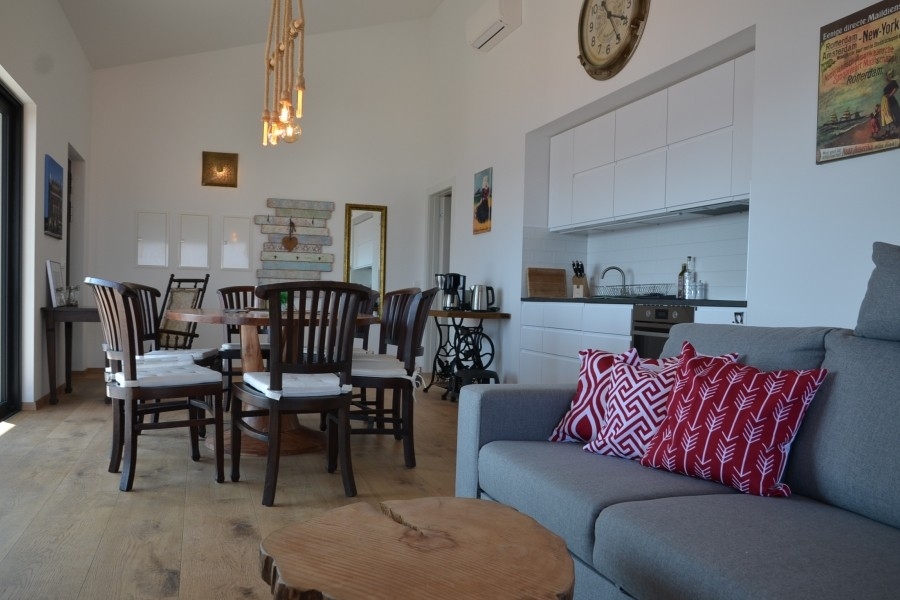 Otevřený obývací prostor s kuchyní a jídelním stolem