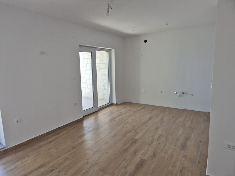 Místnost se dvěma dveřmi a světlou dřevěnou podlahou