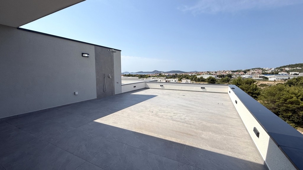 Široká střešní terasa s výhledem na Vodice na moře, apartmán A4107