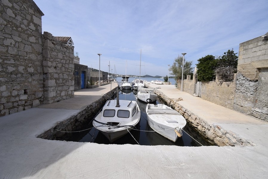 V domě je malý člun s přívěsným motorem.