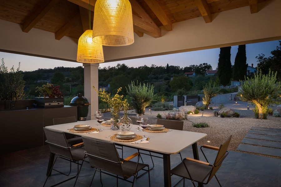 Krytá terasa s jídelním stolem a atmosférickým osvětlením