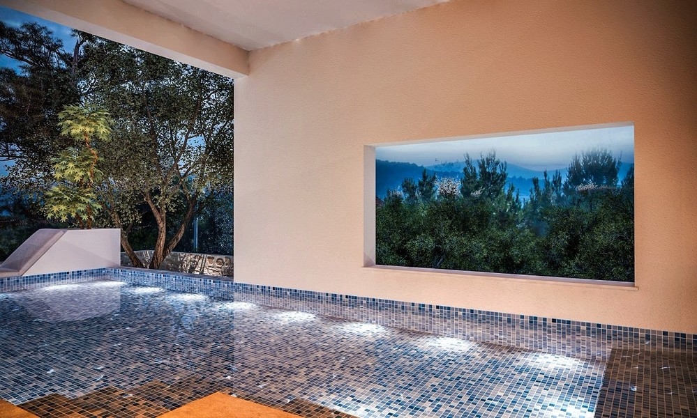 Večerní pohled na osvětlený krytý bazén vily na prodej v Jezera na ostrově Murter, Chorvatsko