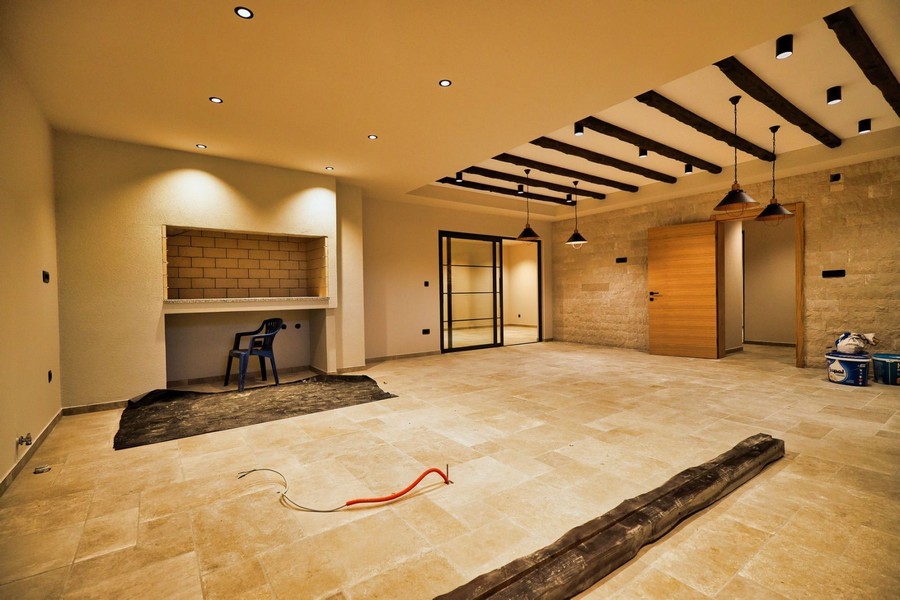 Návrh interiéru nemovitosti na ostrově Krk s moderními podlahami a připraveným krbem