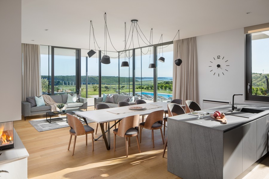 Jídelna a kuchyně a výhled na moře v dálce.