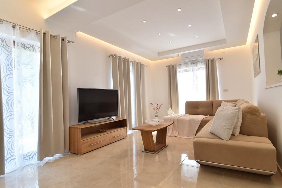 Moderní obývací pokoj s pohovkou a televizí