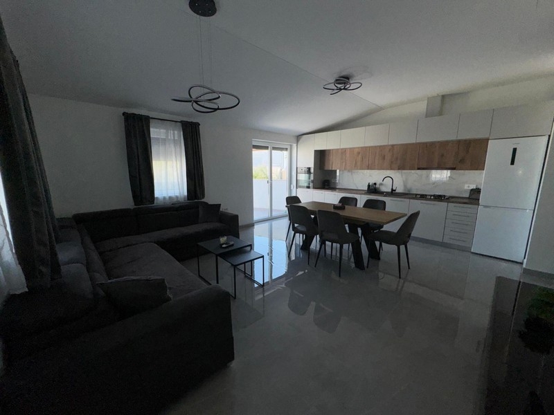 Moderní obývací pokoj s otevřenou kuchyní a jídelním koutem