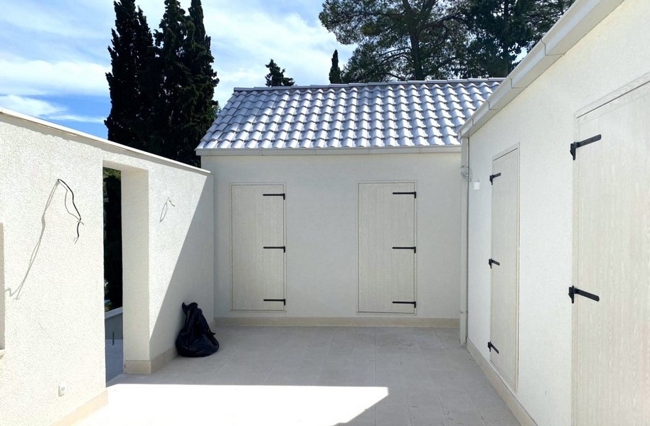 Nádvoří s bílými stěnami a střešními taškami