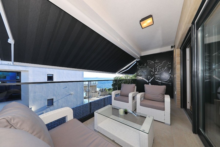 Krytá terasa s posezením a částečným výhledem na moře