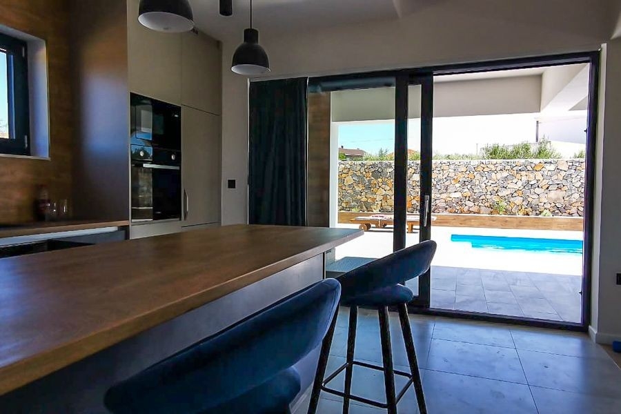 Kuchyň s výhledem na terasu a bazén